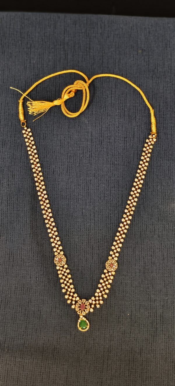 Traditional Gold Necklace with Floral Motifs and Green Pendant